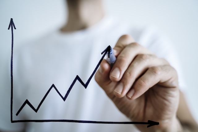 Business growth sale concept. Hand draws a graph of economic profit growth and development
