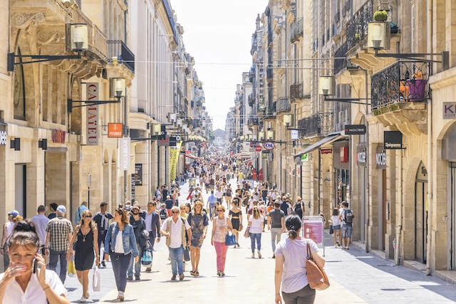 Bordeaux, France - June 14, 2017: People walk on Rue Sainte-Catherine in center of Bordeaux city. The Rue Sainte-Catherine, a 1.2 km long pedestrian street, is the main shopping street in Bordeaux