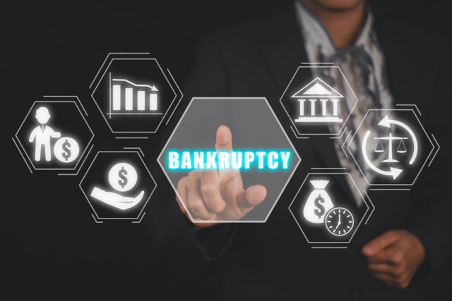 Bankruptcy concept, Business woman hand touching bankruptcy icon on virtual screen.