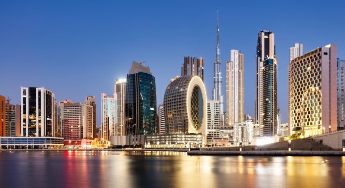 Panaroma of Dubai skyline with Burj khalifa and other skyscrapers at night from Al Jadaf Waterfront; UAE