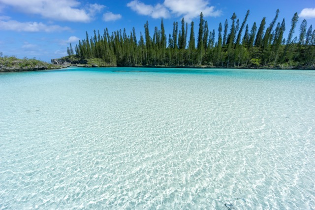 beautiful seascape of natural swimming pool of Oro Bay, Isle of Pines, New Caledonia. aquamarine translucent water.