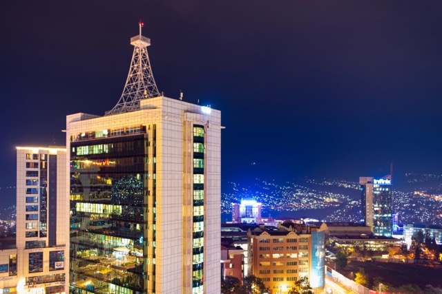 Kigali, Rwanda - August 17 2022: Kigali city centre lit up at night with Pension Plaza, City Tower and other buildings in view.